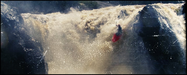 kayaker over waterfall